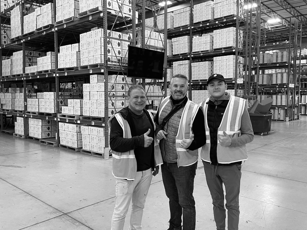 Devin with team at warehouse